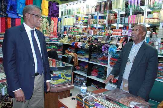 Photograph of AMISOM Ambassador Maman Sidikou with a Somali Minnesotan business owner.