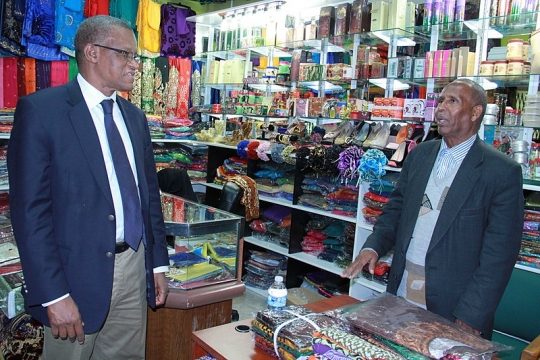 Photograph of AMISOM Ambassador Maman Sidikou with a Somali Minnesotan business owner.