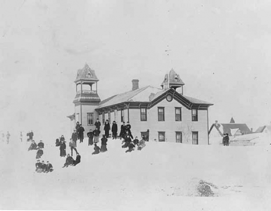 photograph of Dawson school with children playing in the snow.