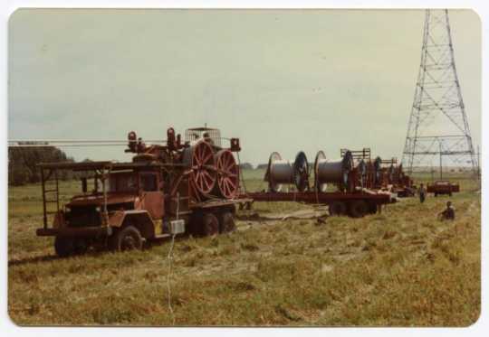 A drum puller and reels of cable being strung for the Cooperative Power Association, Minneapolis, Minnesota/United Power Association, Elk River, Minnesota high-voltage power-line construction through Grant County, Minnesota, 1976–1978.