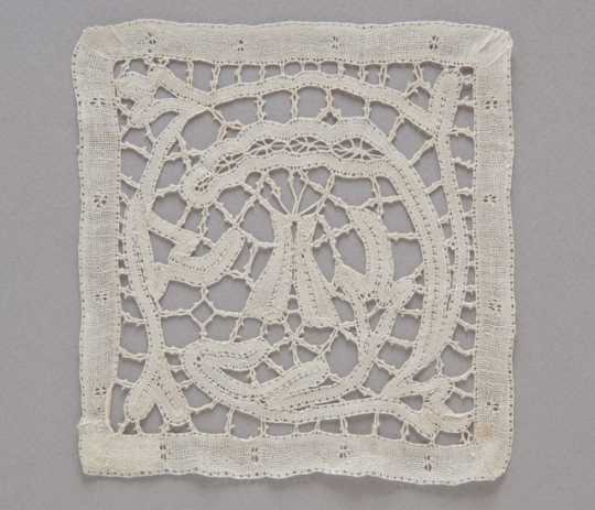photograph of a lace doily featuring a tipi motif