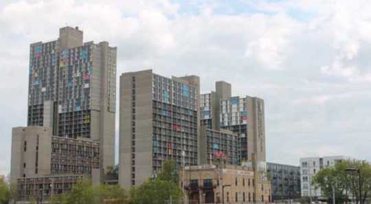 Color image of the he skyline of the Cedar-Riverside neighborhood of Minneapolis viewed from the north. At center are the Riverside Plaza complex of apartment buildings and Mixed Blood Theatre. Photograph by Ibrahim Hirsi, May 3, 2017.