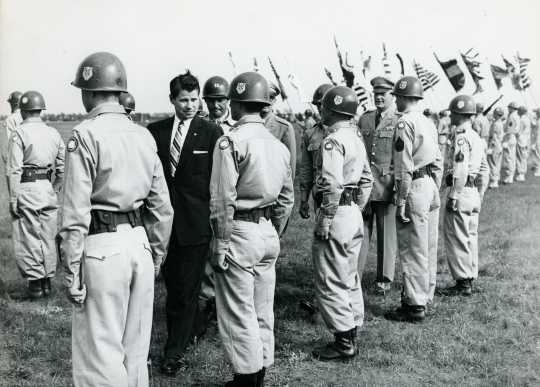 Black and white photograph of Governor Orville Freeman inspecting his troops at Camp Ripley, 1955.