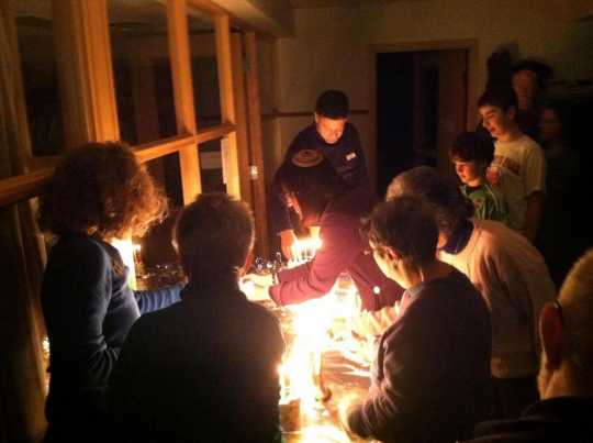 Color image of Mayim Rabim Congregation members gathered to celebrate Chanukah, 2013. 