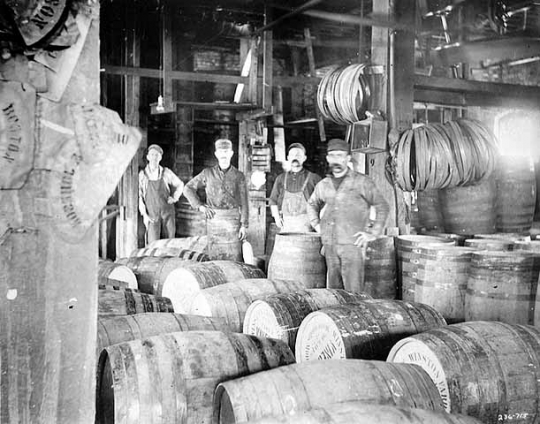 Black and white photograph of M. A. Company workers constructing vinegar barrels, c.1912.