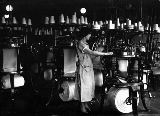 photograph of a woman operating a Munsingwear knitting machine