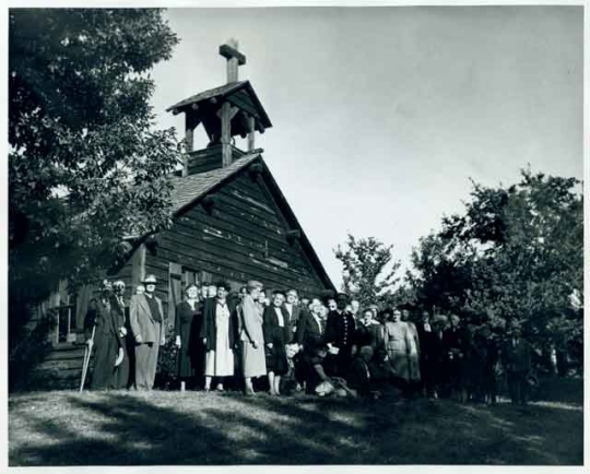 Group outside the reconstructed Lac qui Parle Mission