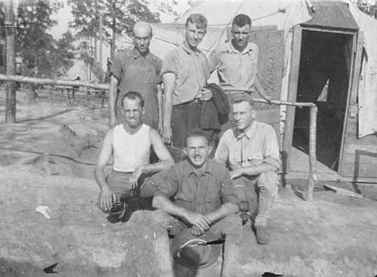Black and white photograph of Adolf Dehn (standing at right) while serving time in the guard house of an army camp, Spartanburg, South Carolina, 1918.