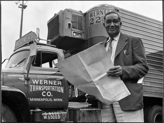 Black and white photograph of Frederick McKinley Jones standing next to a truck outfitted with a mobile refrigeration unit, c.1950.