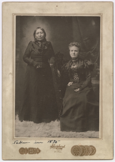 Mary E. Schwandt Schmidt (Mrs. William) and Snana Good Thunder (Maggie Brass), 1899. Photo by Shepherd Photo Studio.