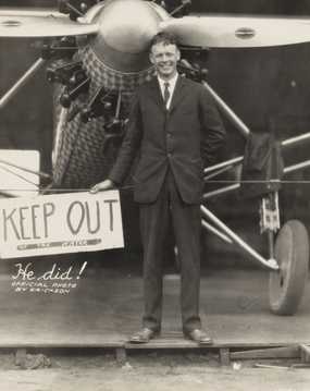 Black and white photograph of Charles Augustus Lindbergh with his plane, c.1927.