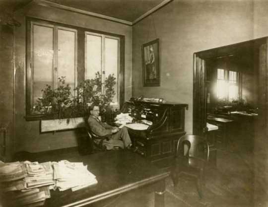 Black and white photograph of Swan Turnblad in his office at the Svenska Amerikanska Posten, ca. 1920.